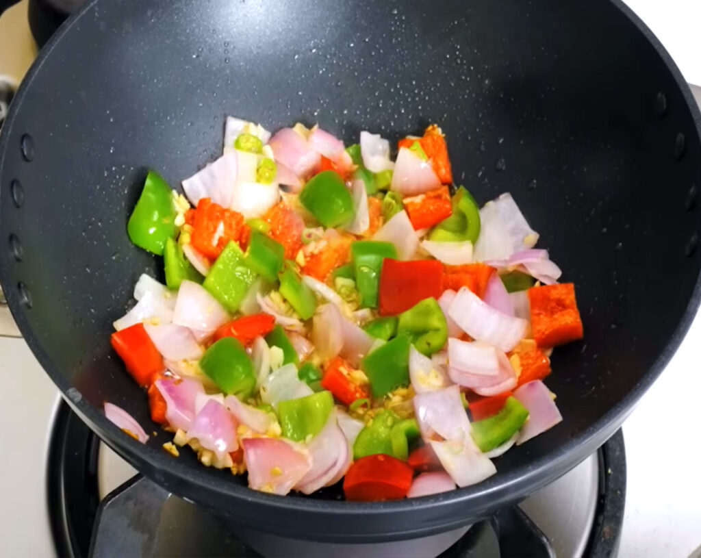 preparing veg manchurian gravy gravy ingredients chopped onions, tomatoes, bell peppers