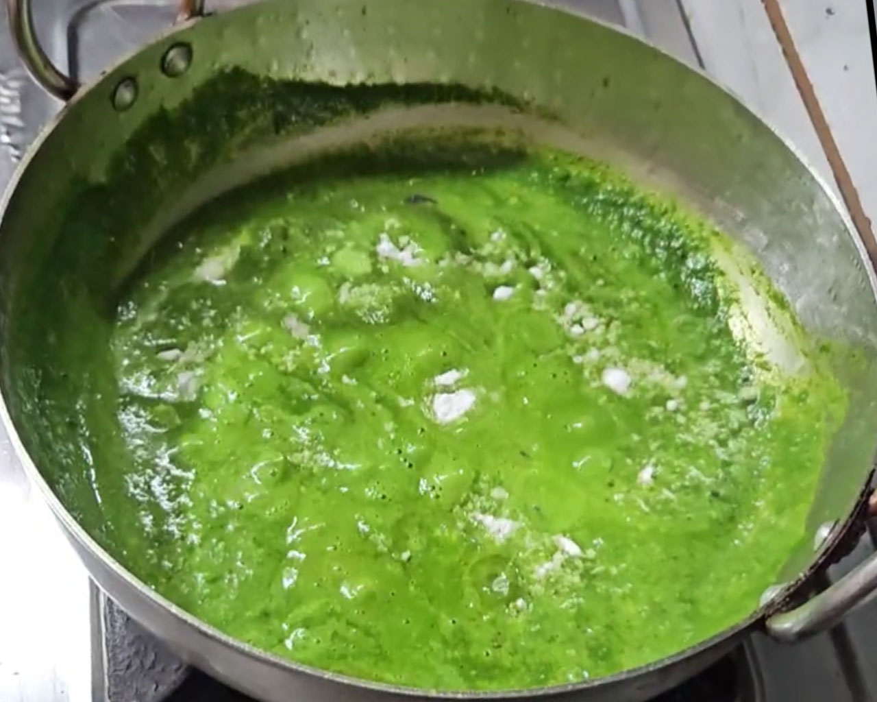 Salt being added in palak spinach