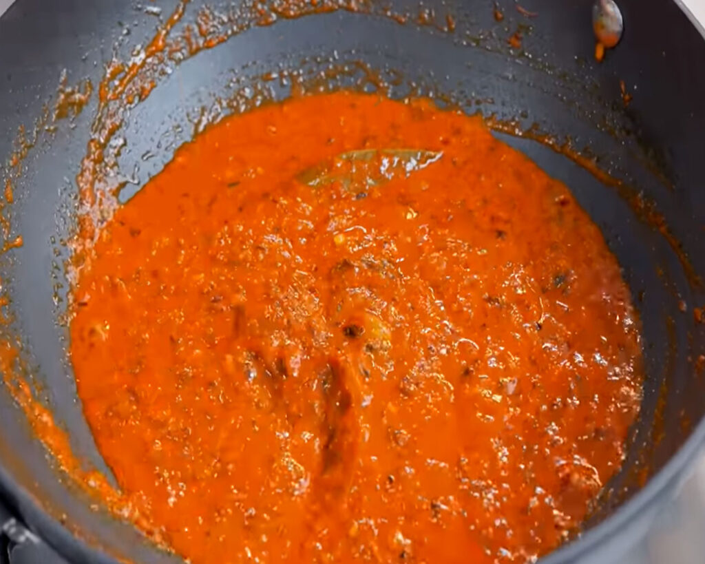 Tomato puree simmering in spices and onions for rich butter paneer masala curry