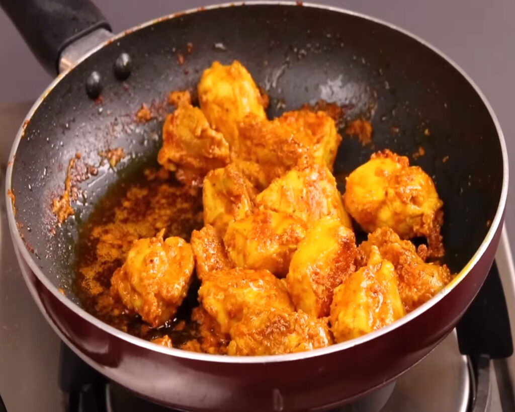 Cooked chicken pieces after being browned on all sides in a pan