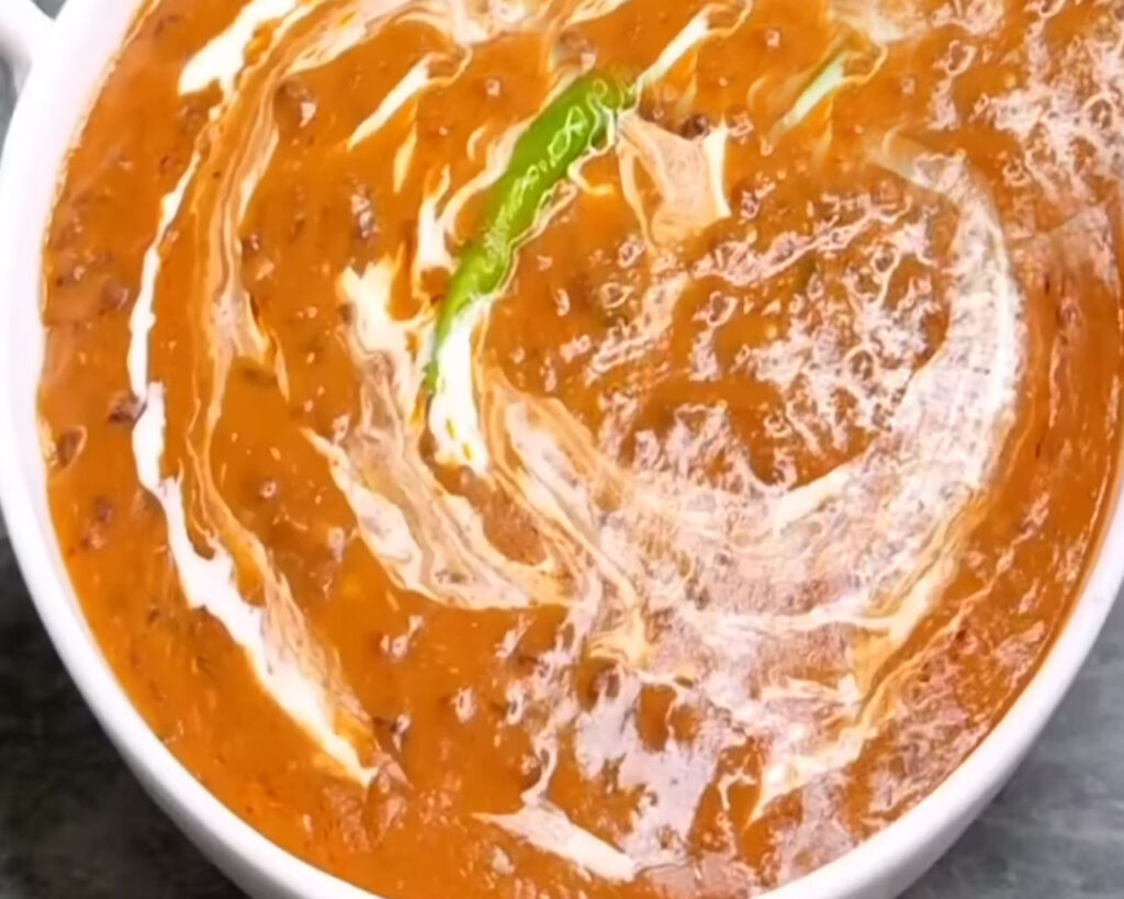 Garnish Dal Makhani with Cream