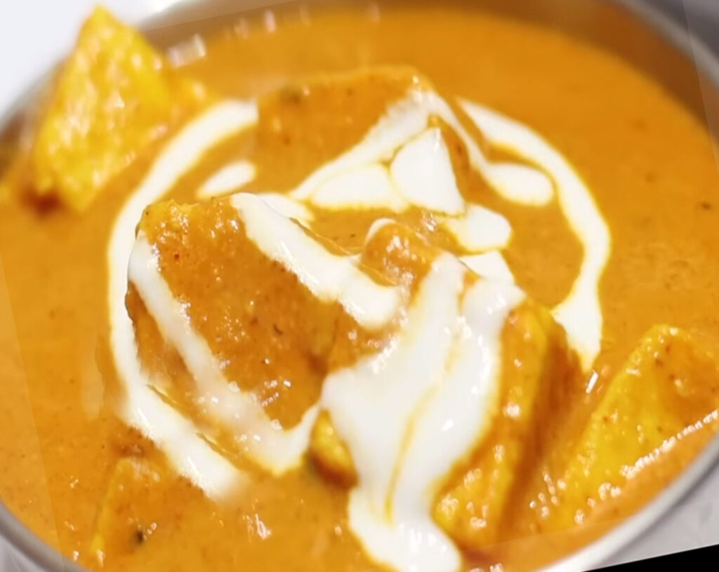 Cream and fresh coriander garnishing Shahi Paneer, ready to serve with naan or rice.
