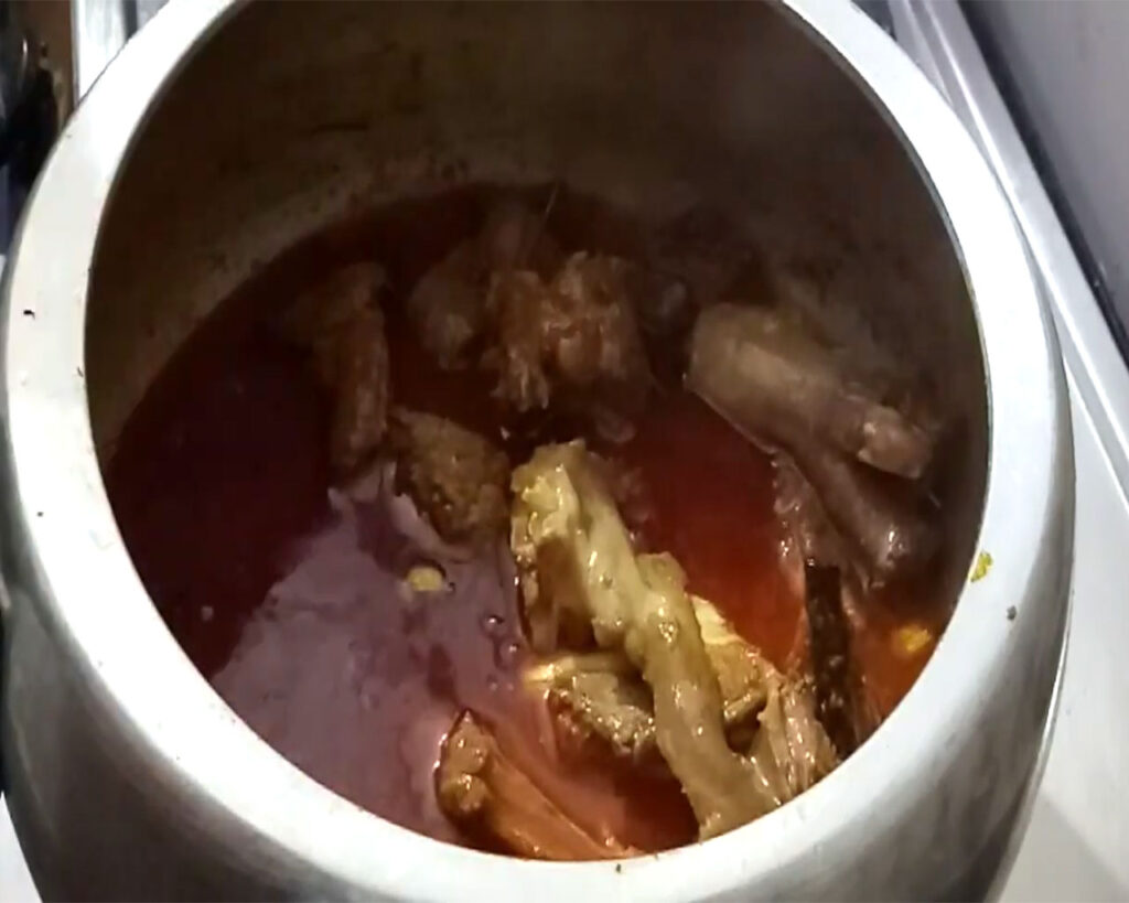 Ginger-garlic paste and saffron strands added to the Rogan Josh recipe mutton gravy before pressure cooking.