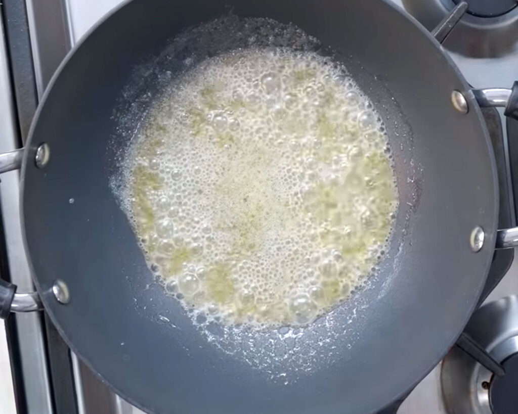 Hot oil and melting butter in a pan for making paneer butter masala base