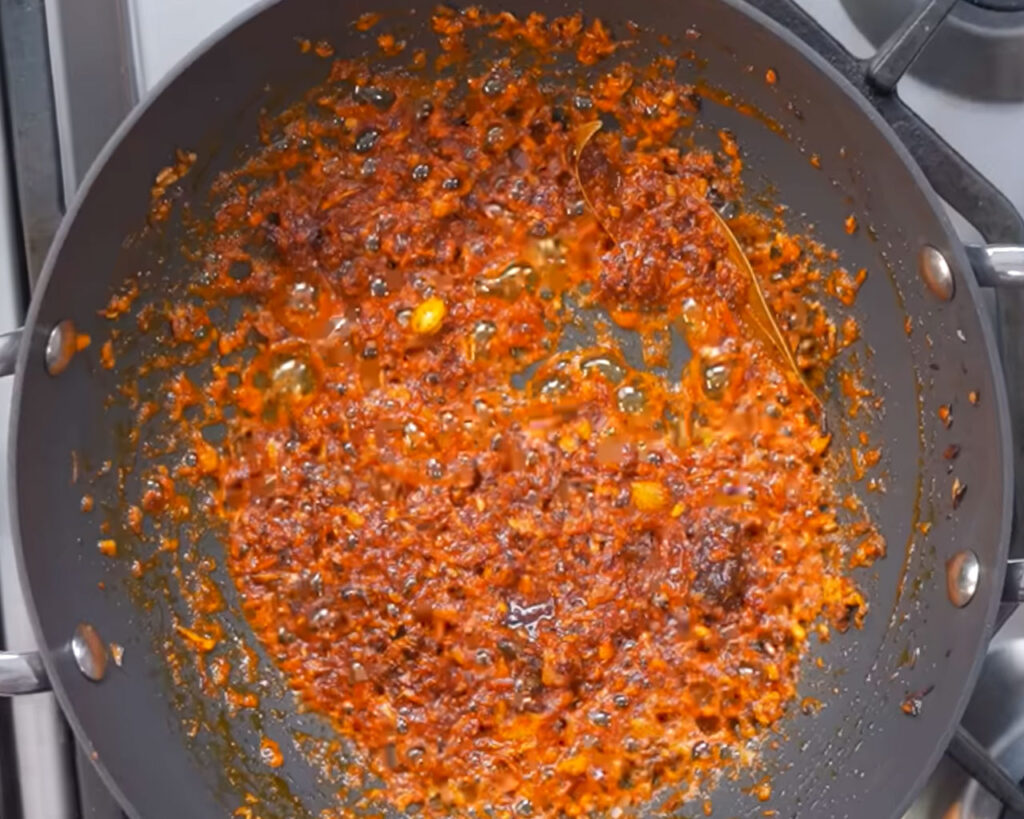 Preparing paneer butter masala gravy