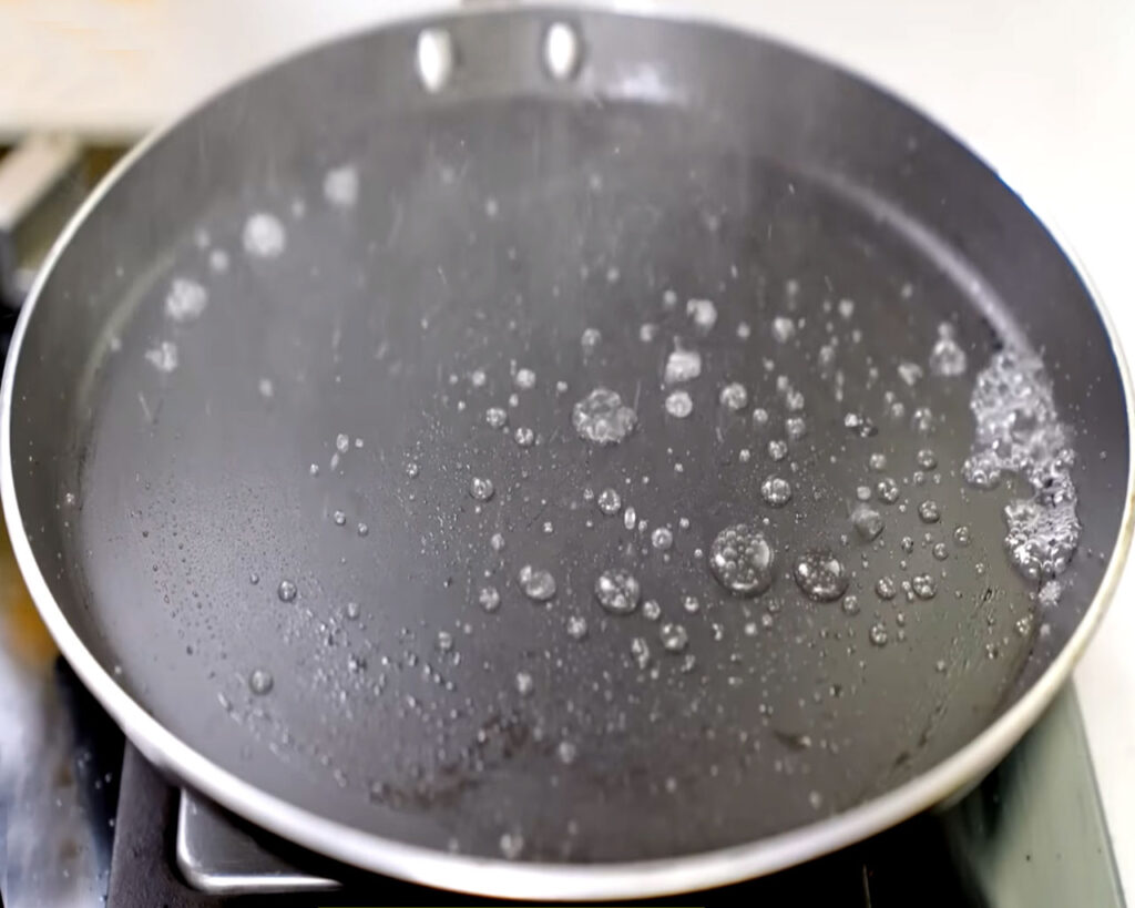 Non stick or iron cast tawa (griddle) for cooking dosa