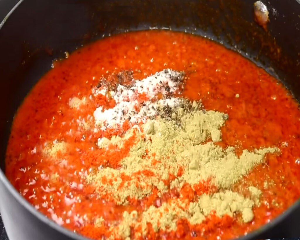 adding bhindi masala spices ingredients in gravy
