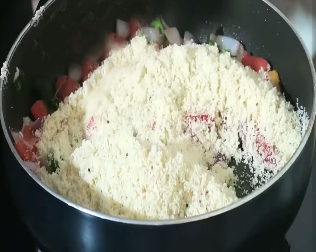 Slowly pouring roasted rava in pan