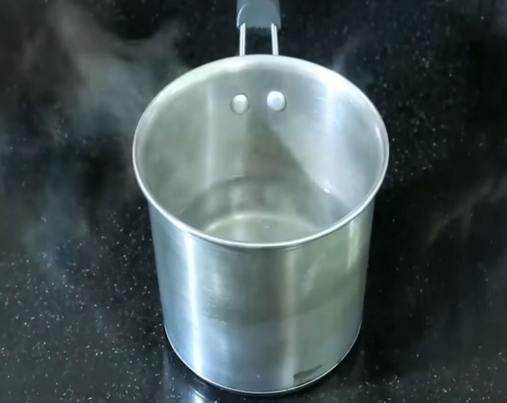 Water boiling in the pan before adding rava to cook upma