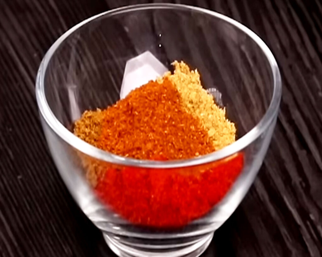 Indian spices and water mixed in a bowl to make a thick masala paste for chicken tikka