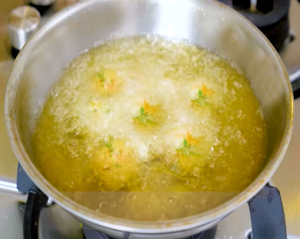 deep frying veg manchurian balls in hot oil