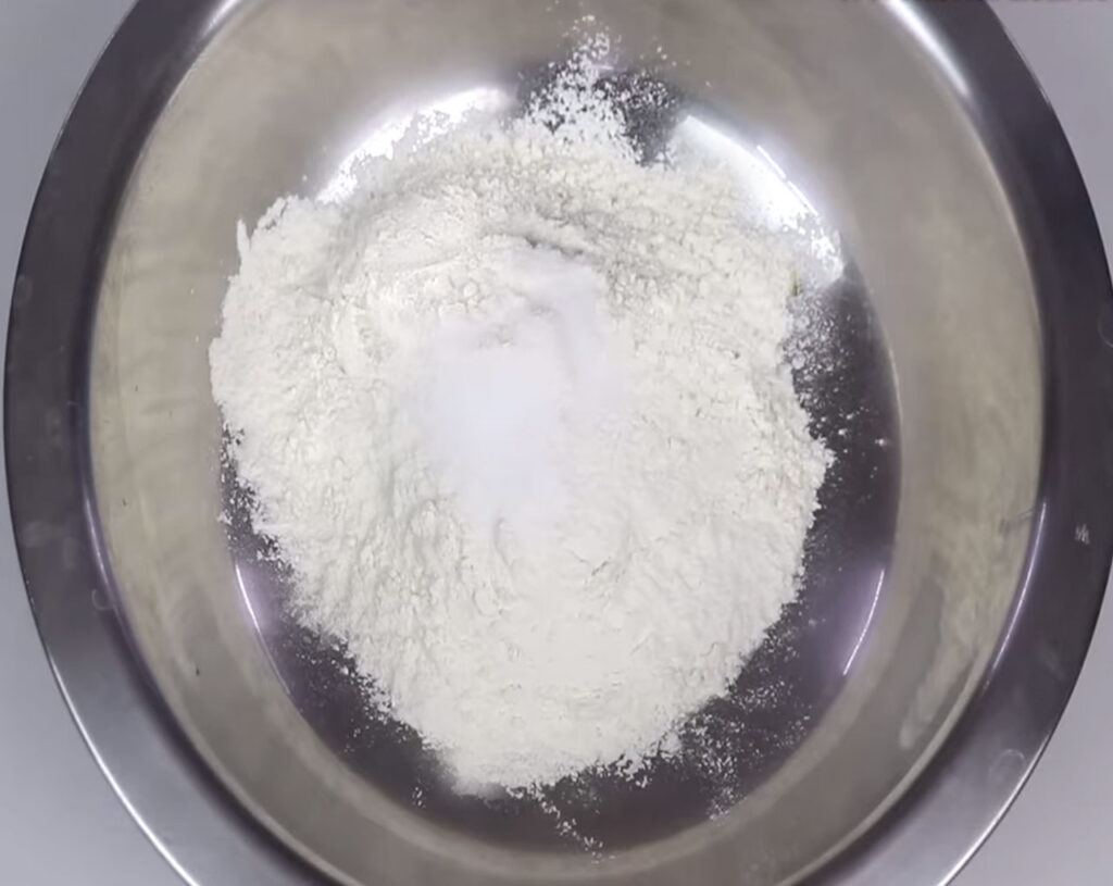 mixing flour and salt to prepare dough for veg momos