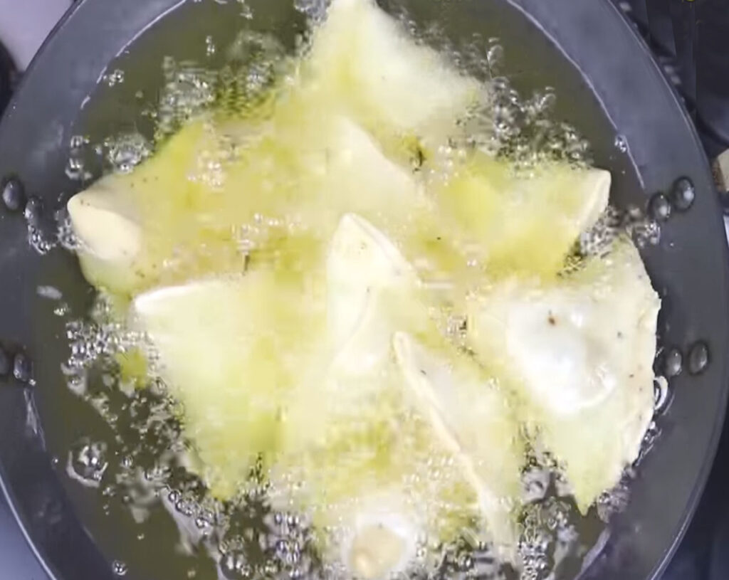 samosas deep frying in hot oil