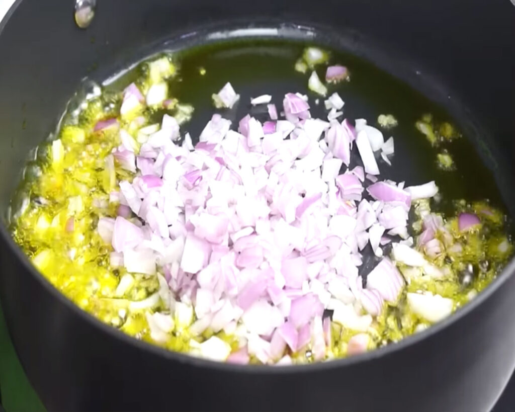 Sauteing chopped onions in hot oil for preparing bhindi masala