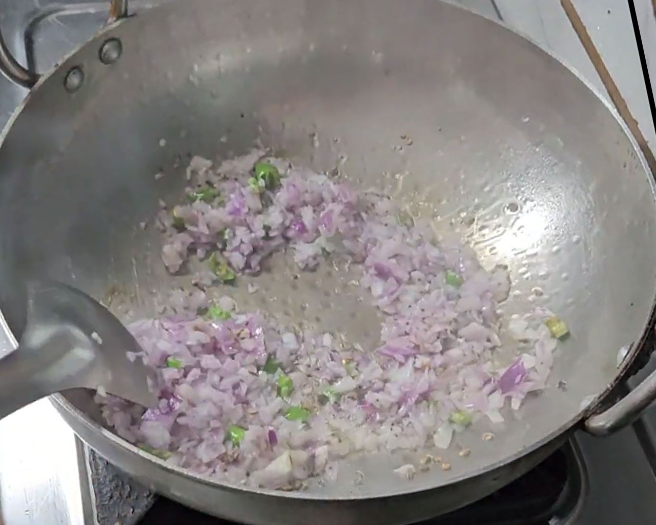 Sauteing chopped onions for palak paneer gravy