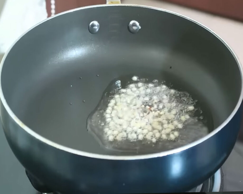 Mustard seeds spluttering in hot oil during tempering for upma