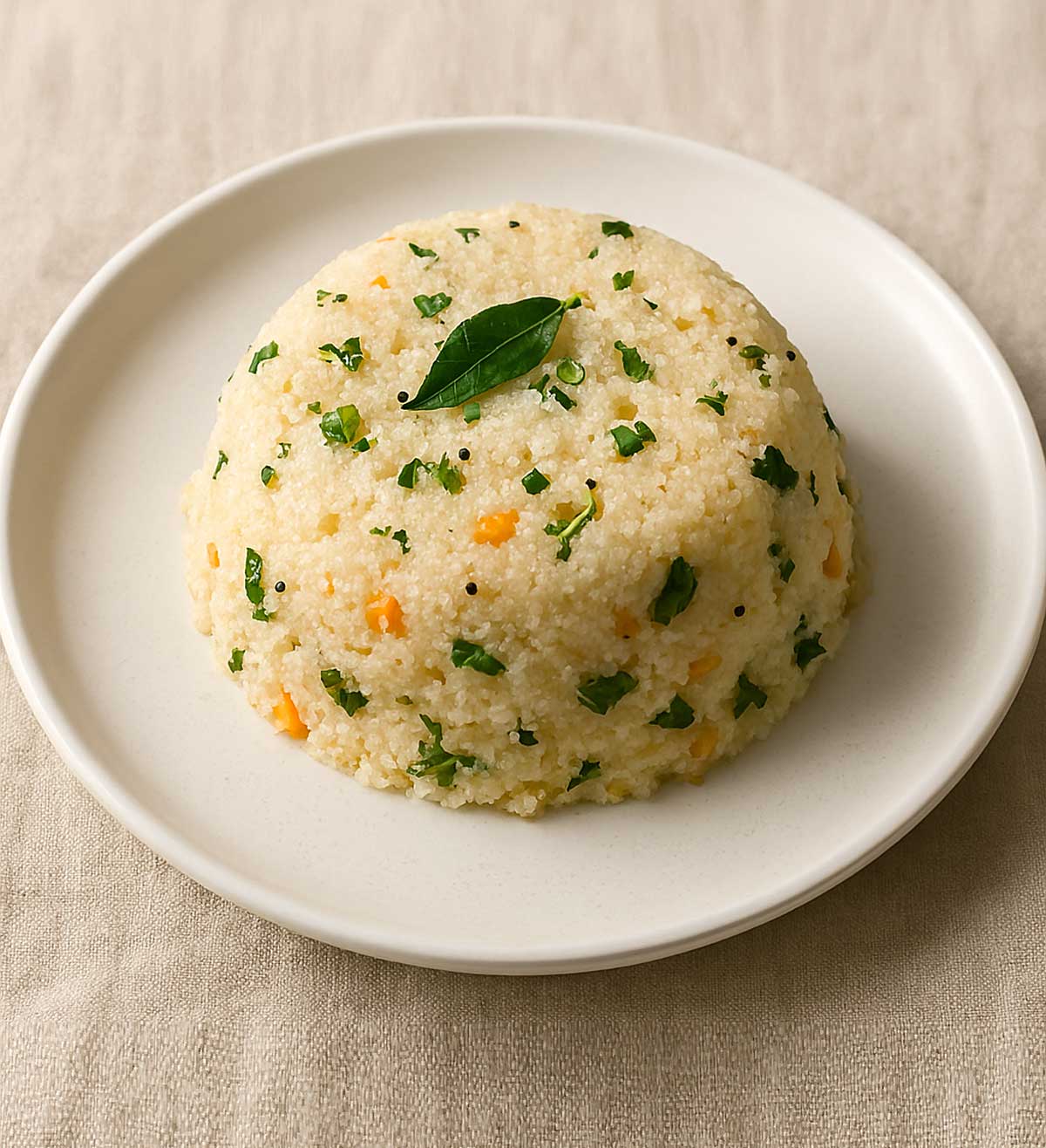 Fluffy semolina upma served on a plate, a popular South Indian vegetarian breakfast recipe made with rava, curry leaves, and spices.