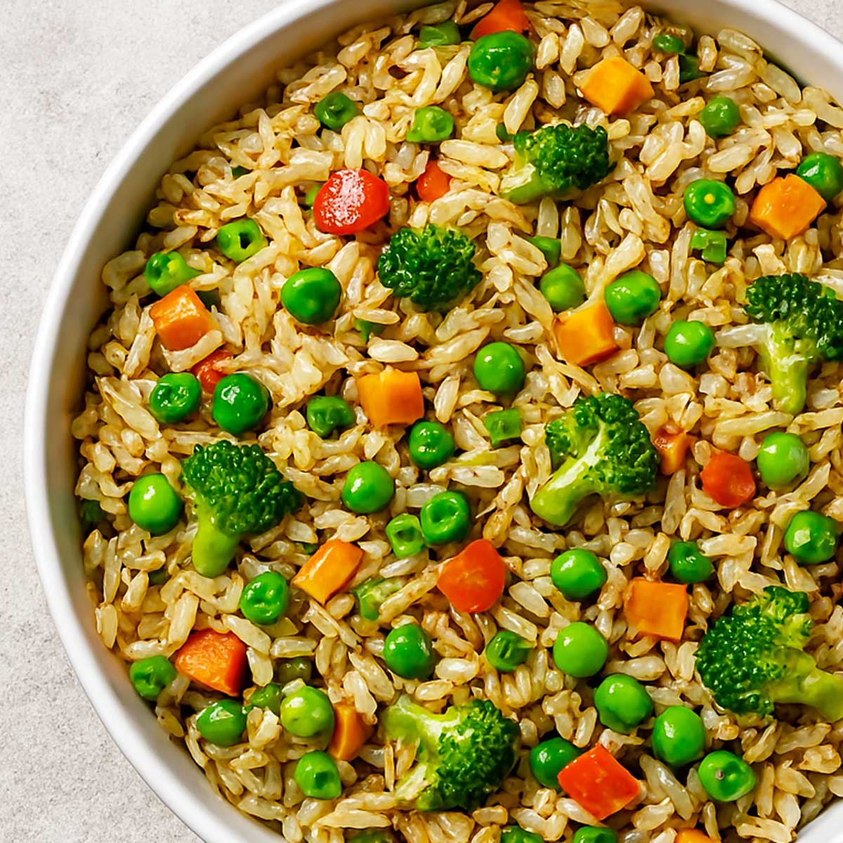 Indian vegetarian fried rice with fluffy basmati rice, stir-fried veggies, and soy sauce, served hot for a delicious meal.