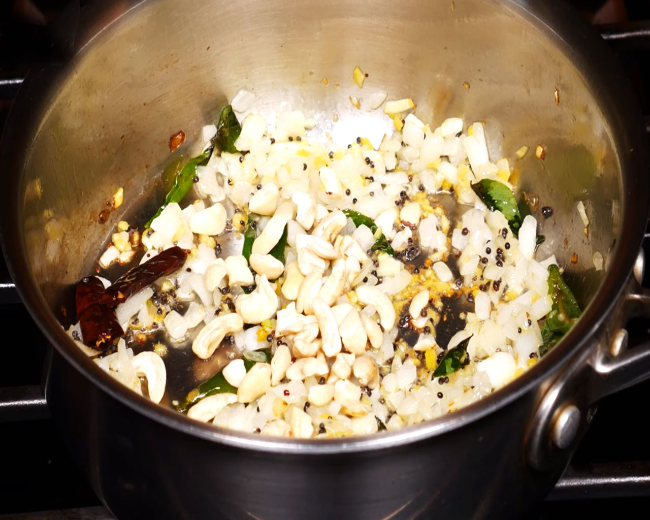 Frying cashews until golden in the pan