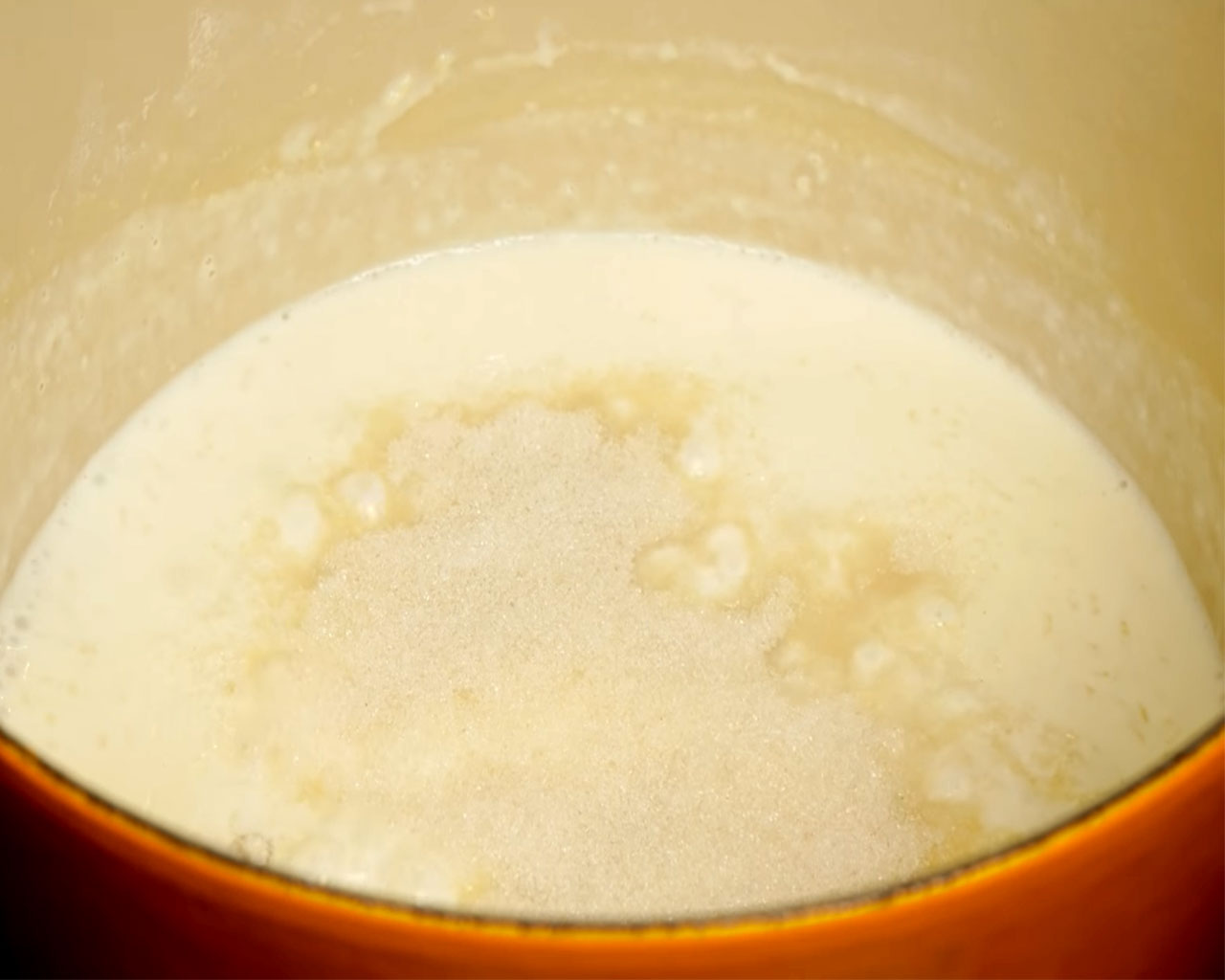 Almonds, cashews, raisins, being added to thickened rice and milk mixture for kheer.