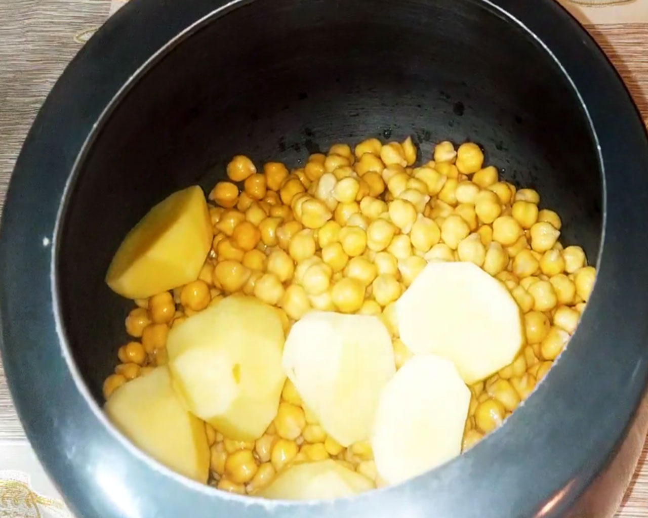 Cooking chickpeas and potatoes for chana masala