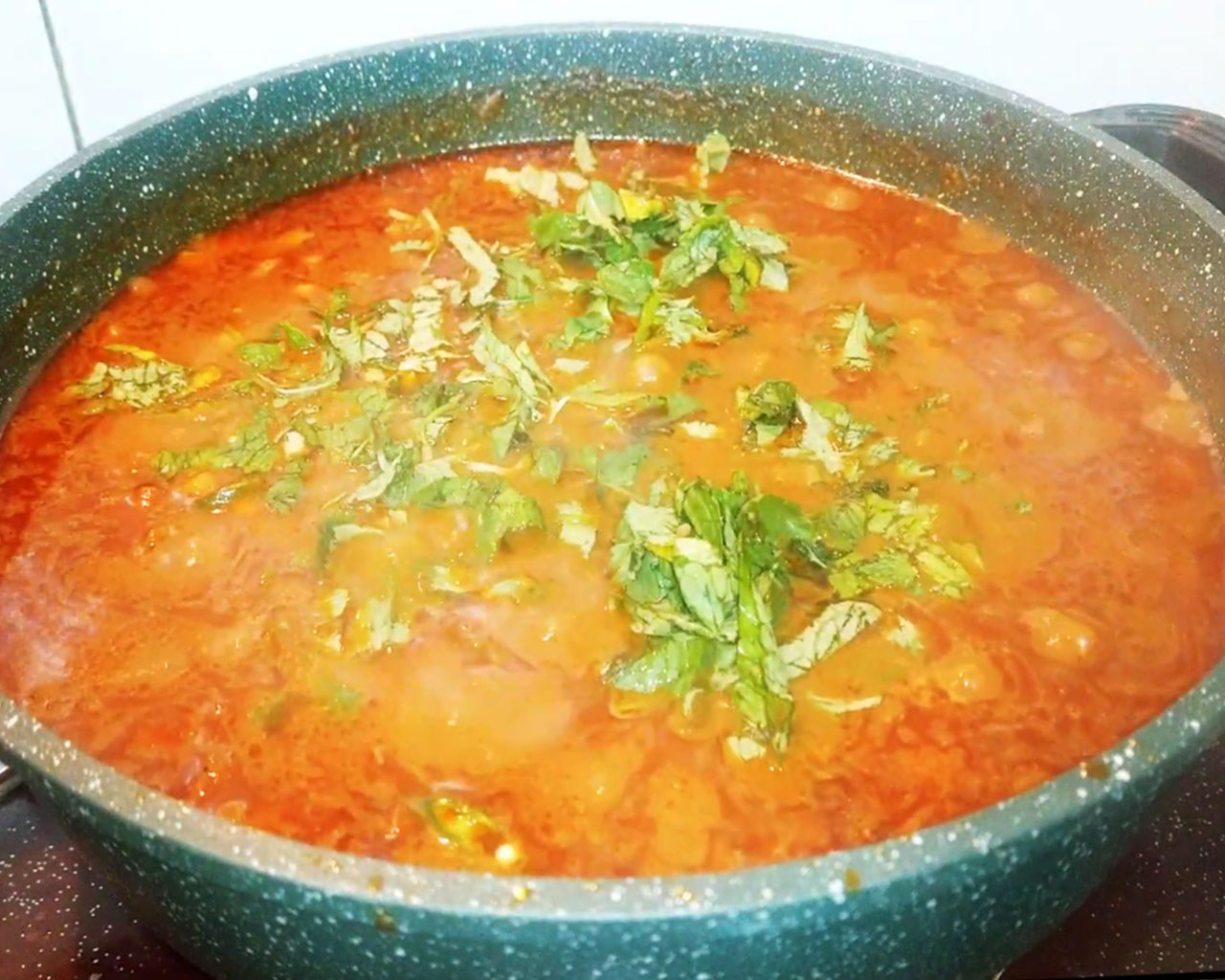 Garnished chana masala with chopped green chilies and mint