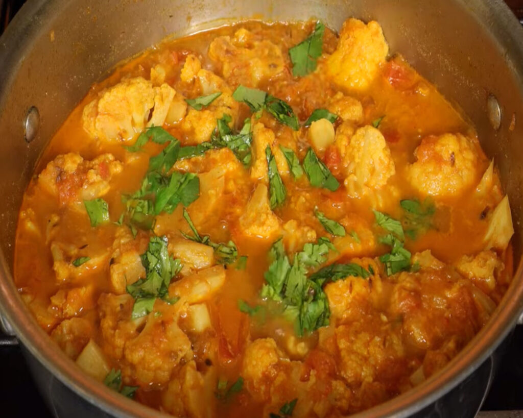 Finished cauliflower curry garnished with fresh coriander leaves ready to serve