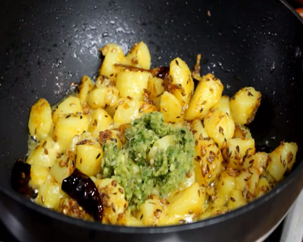 Adding spicy Jeera Aloo ingredients