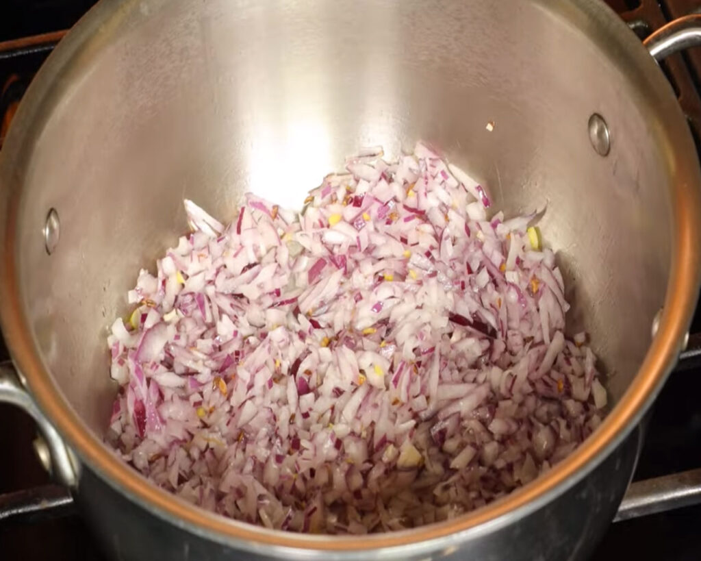 Finely chopped onions cooking until golden brown for curry gravy
