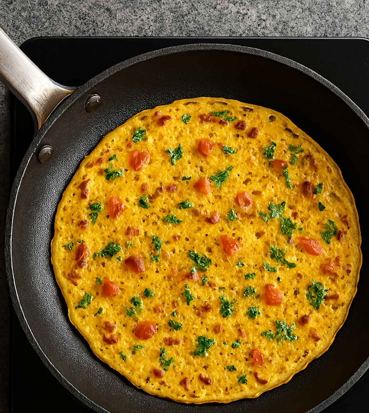 Indian gram flour pancake served on a round plate