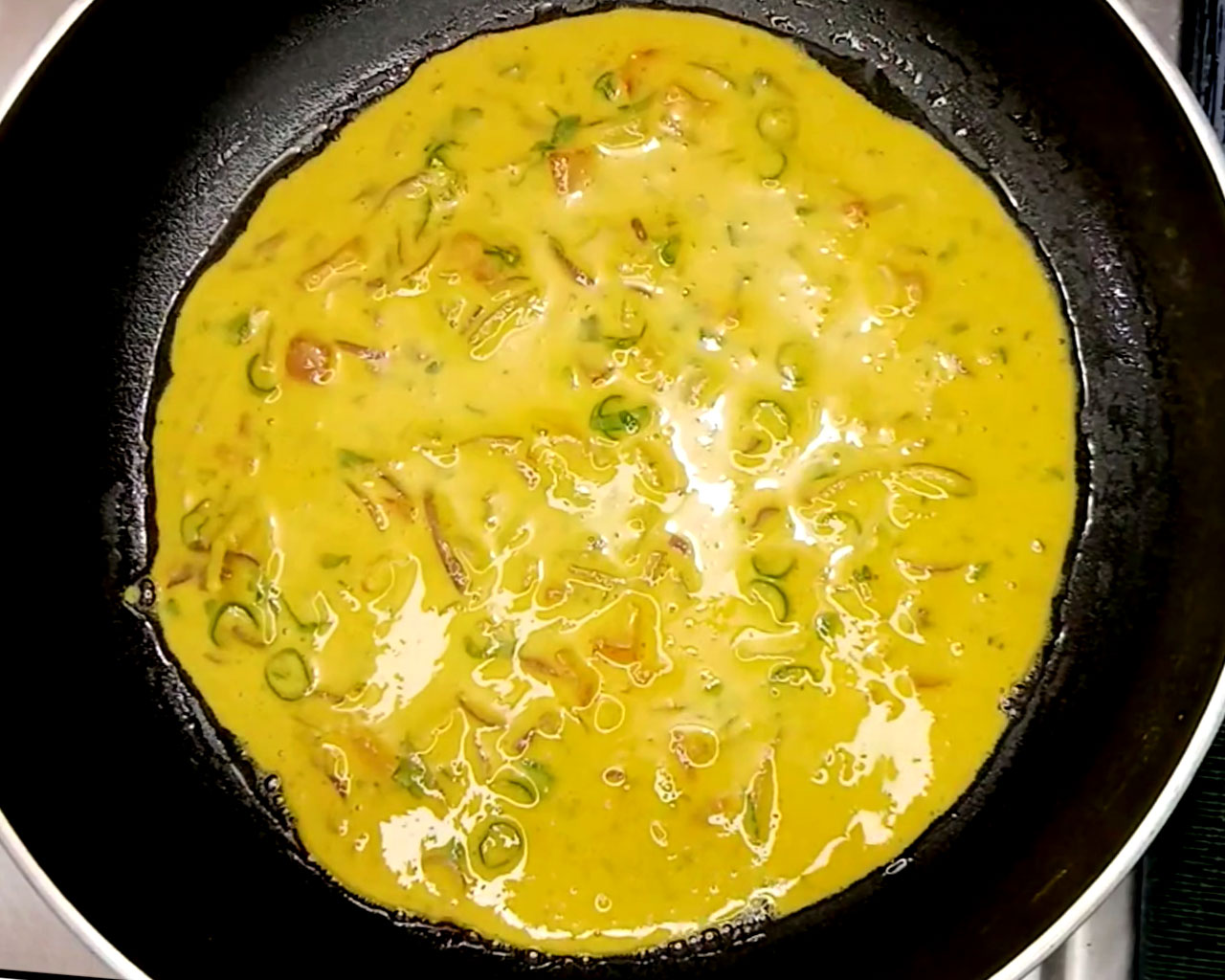 Chilla batter cooking in pan