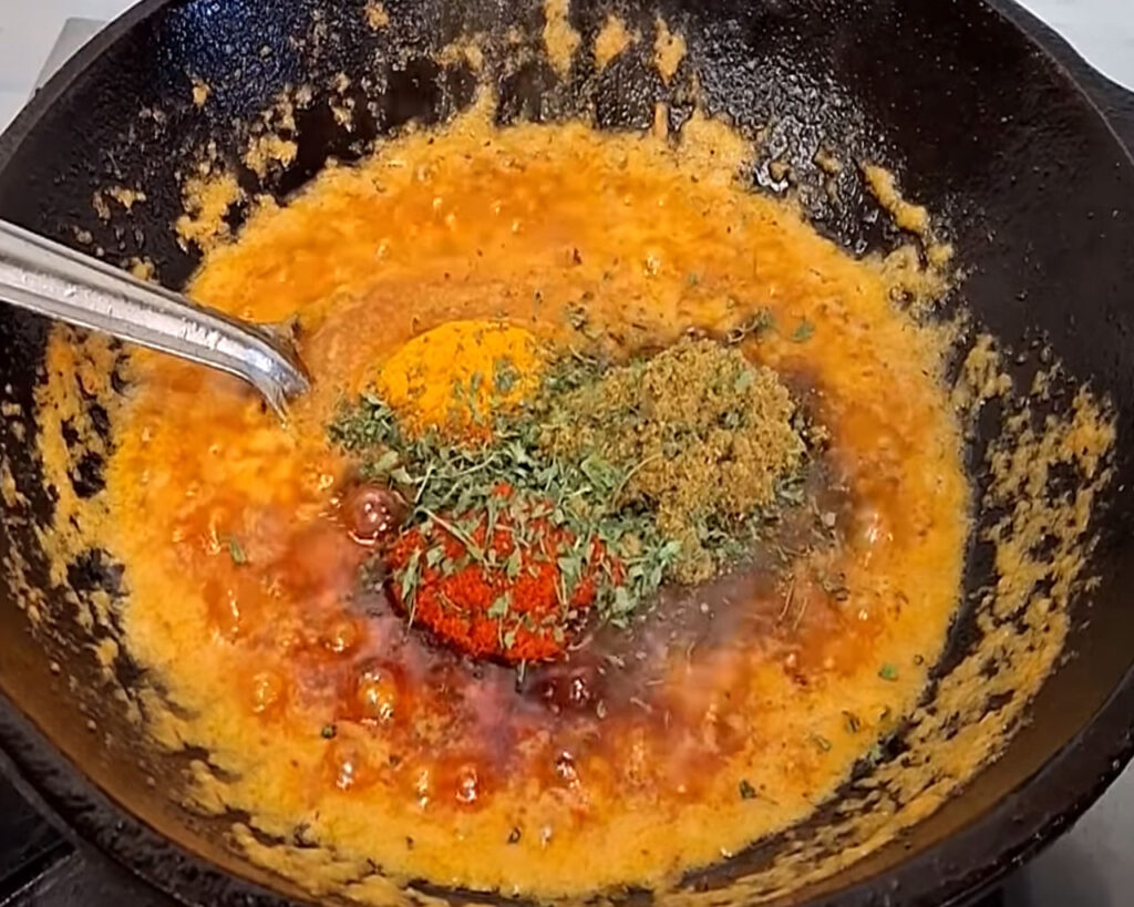 Blended veg kofta curry masala cooking with red chili, turmeric, and garam masala