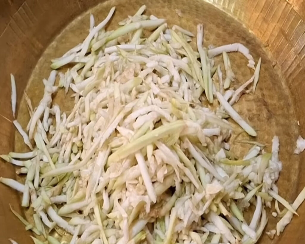 Grated bottle gourd in a plate with water squeezed out for making kofta