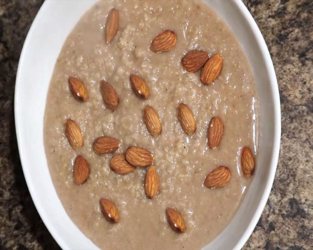 Coconut milk oatmeal recipe with almonds on top
