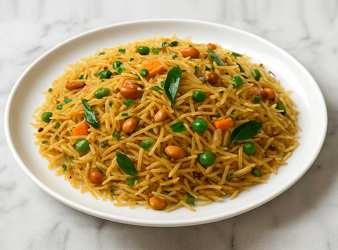 South Indian style vermicelli upma on a plate, garnished with curry leaves, perfect for morning meal.