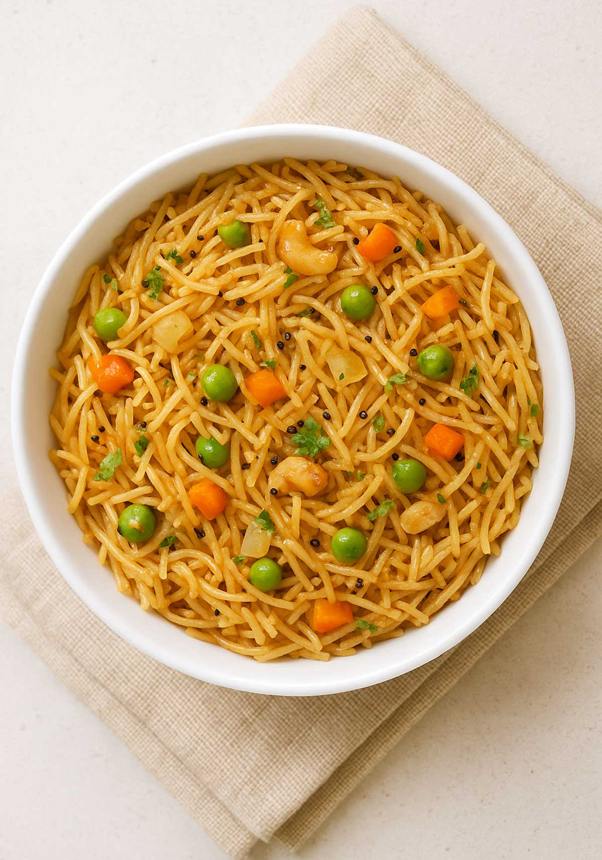 Traditional South Indian Semiya Upma in a white bowl, garnished with coriander leaves served for breakfast.