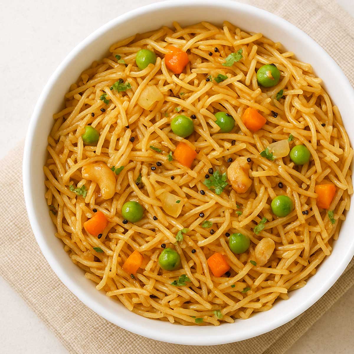 semiya upma served in a bowl with golden cashews and coriander garnish.