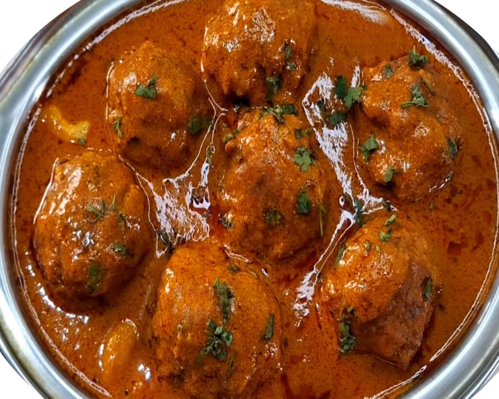 Garnished bottle gourd kofta curry ready to serve with naan or rice