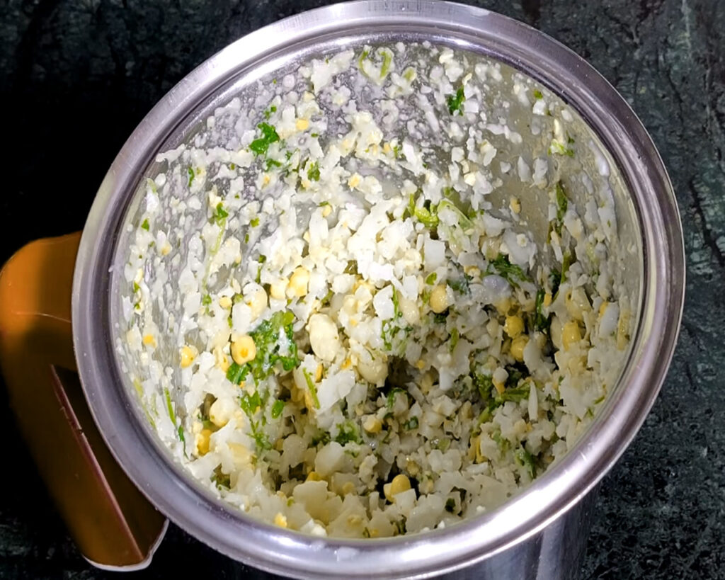 Smooth coconut chutney being adjusted with added water for perfect consistency