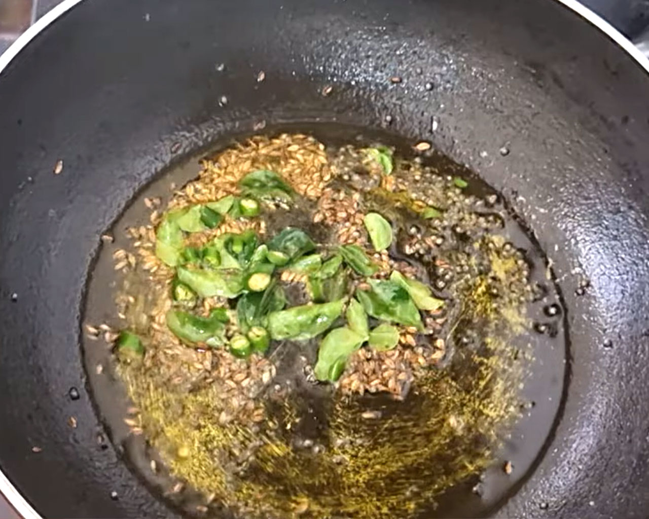 Chopped green chilies added to tadka for spice