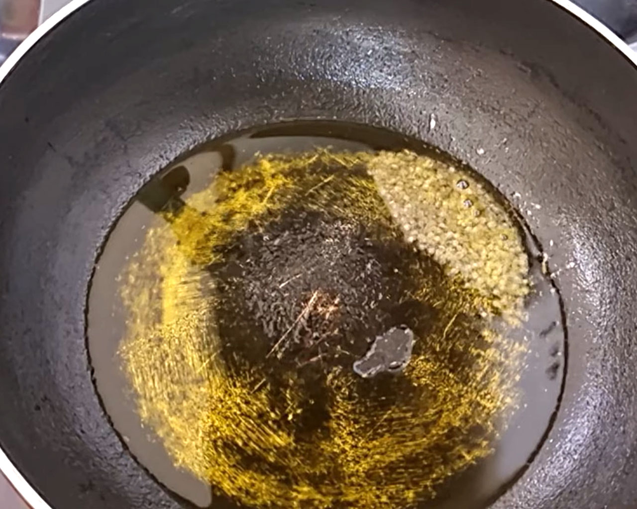 Mustard seeds spluttering in hot oil for tempering