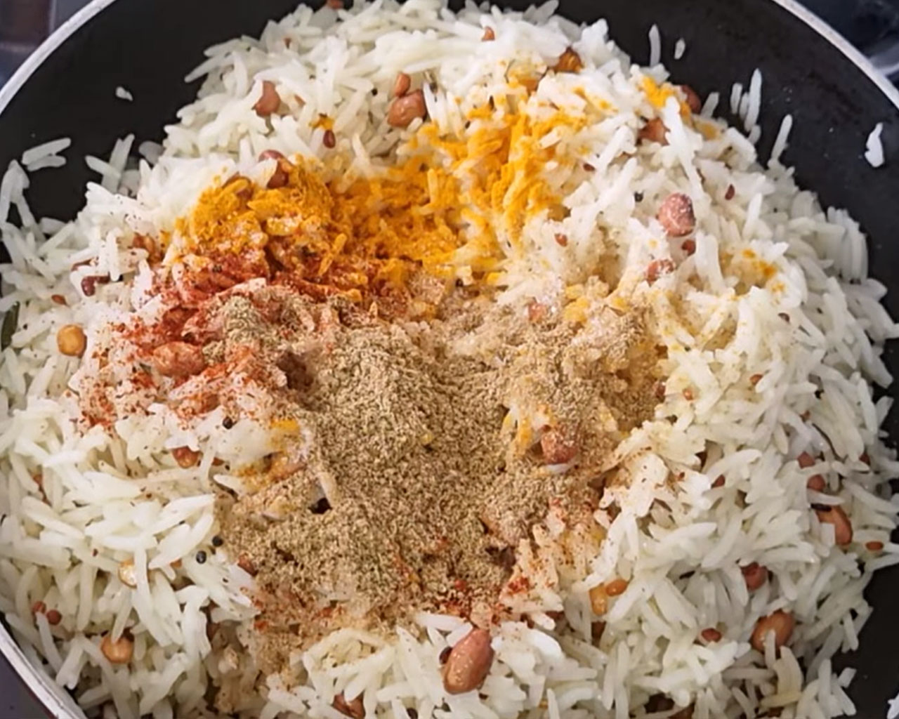 Turmeric, red chili, coriander, and salt added to rice
