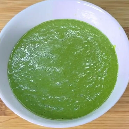 Smooth green mint chutney in a bowl ready to be served with snacks