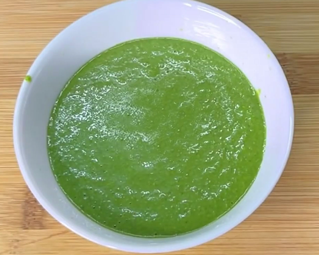 Smooth green mint chutney in a bowl ready to be served with snacks