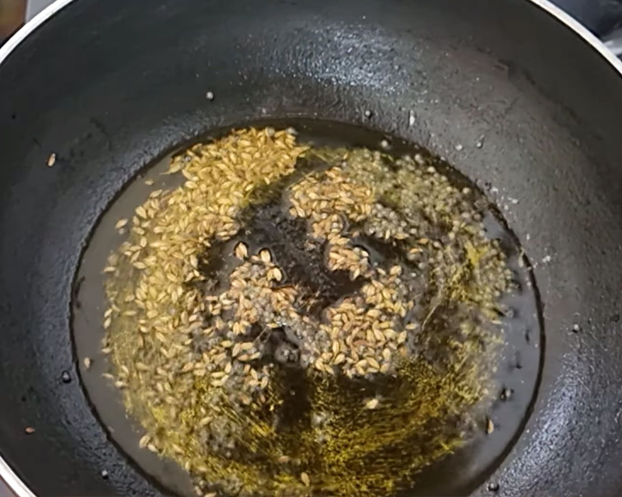 Cumin seeds sizzling in hot mustard oil