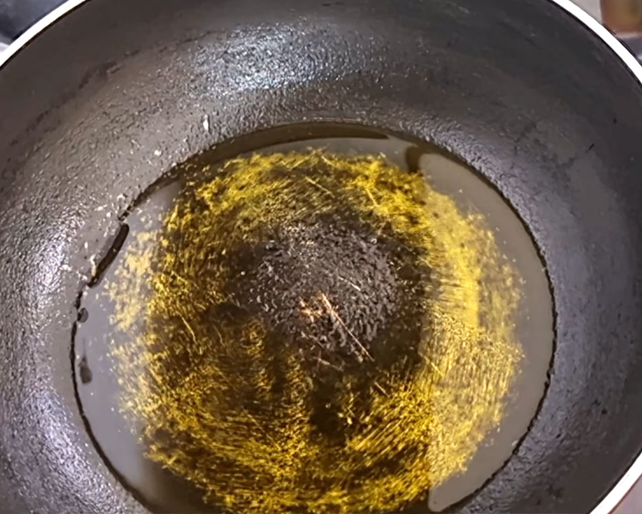 Heating mustard oil in a pan for South Indian lemon rice recipe