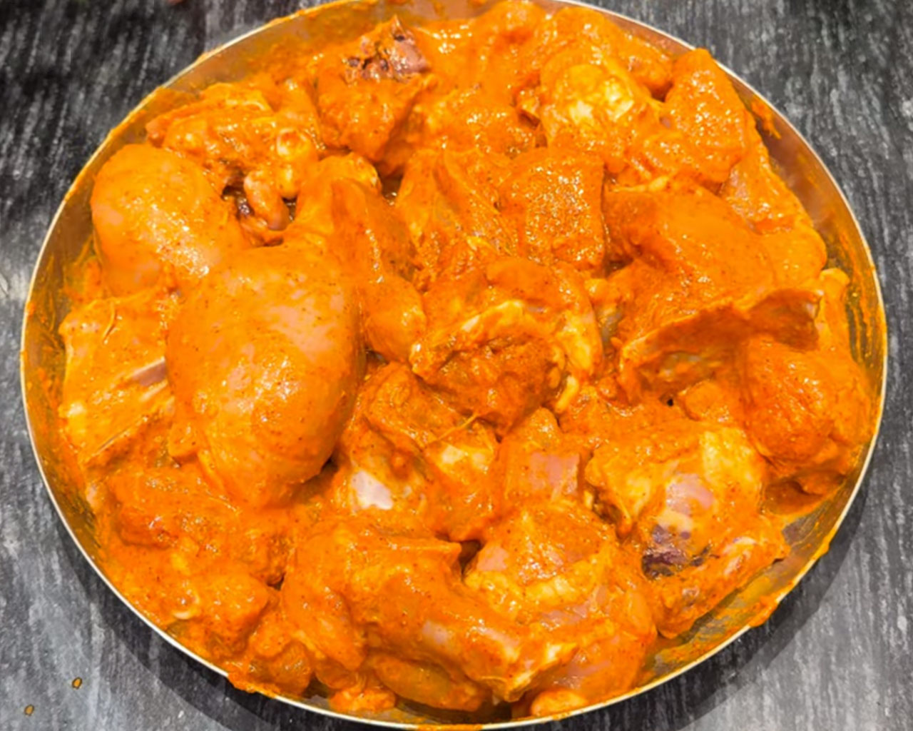 Raw chicken pieces marinated with yogurt, ginger garlic paste, Indian spices