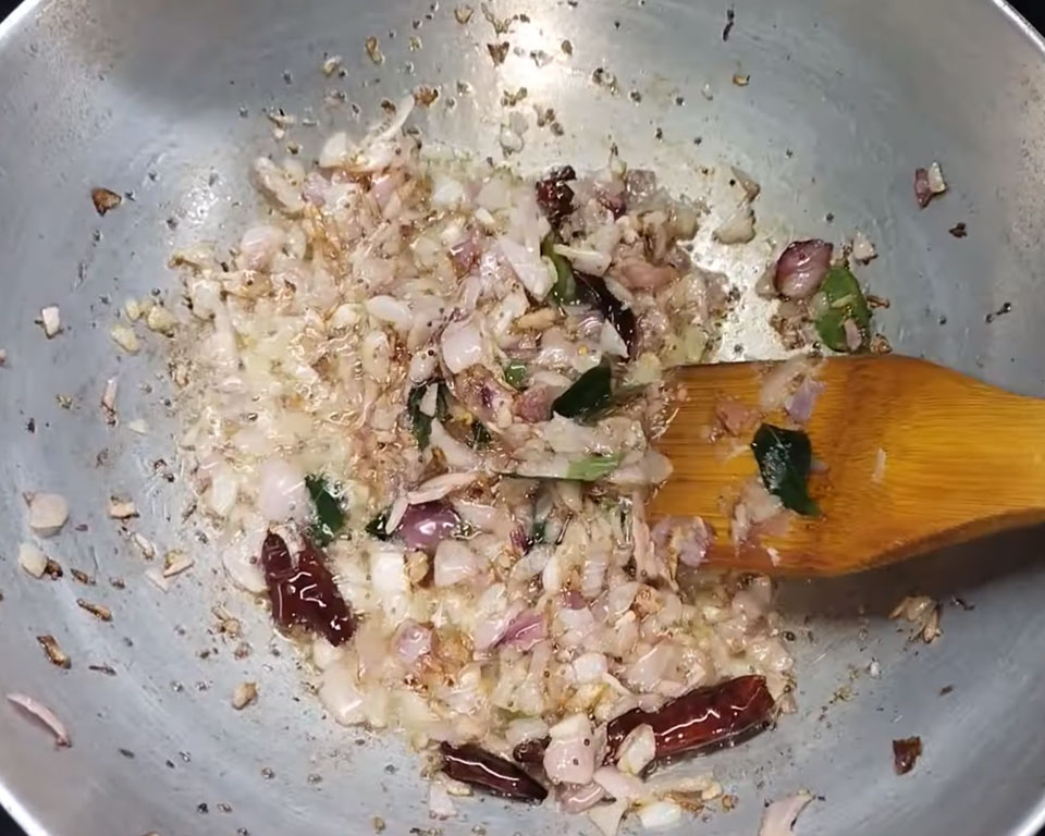 Onions sautéed with curry leaves and spices until golden brown base preparation for South Indian sambar