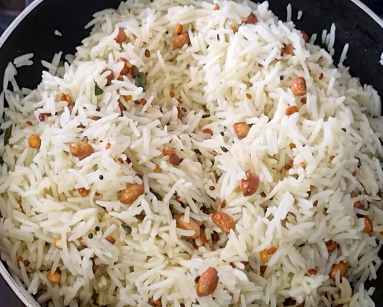 Stirring rice with lemon rice tadka