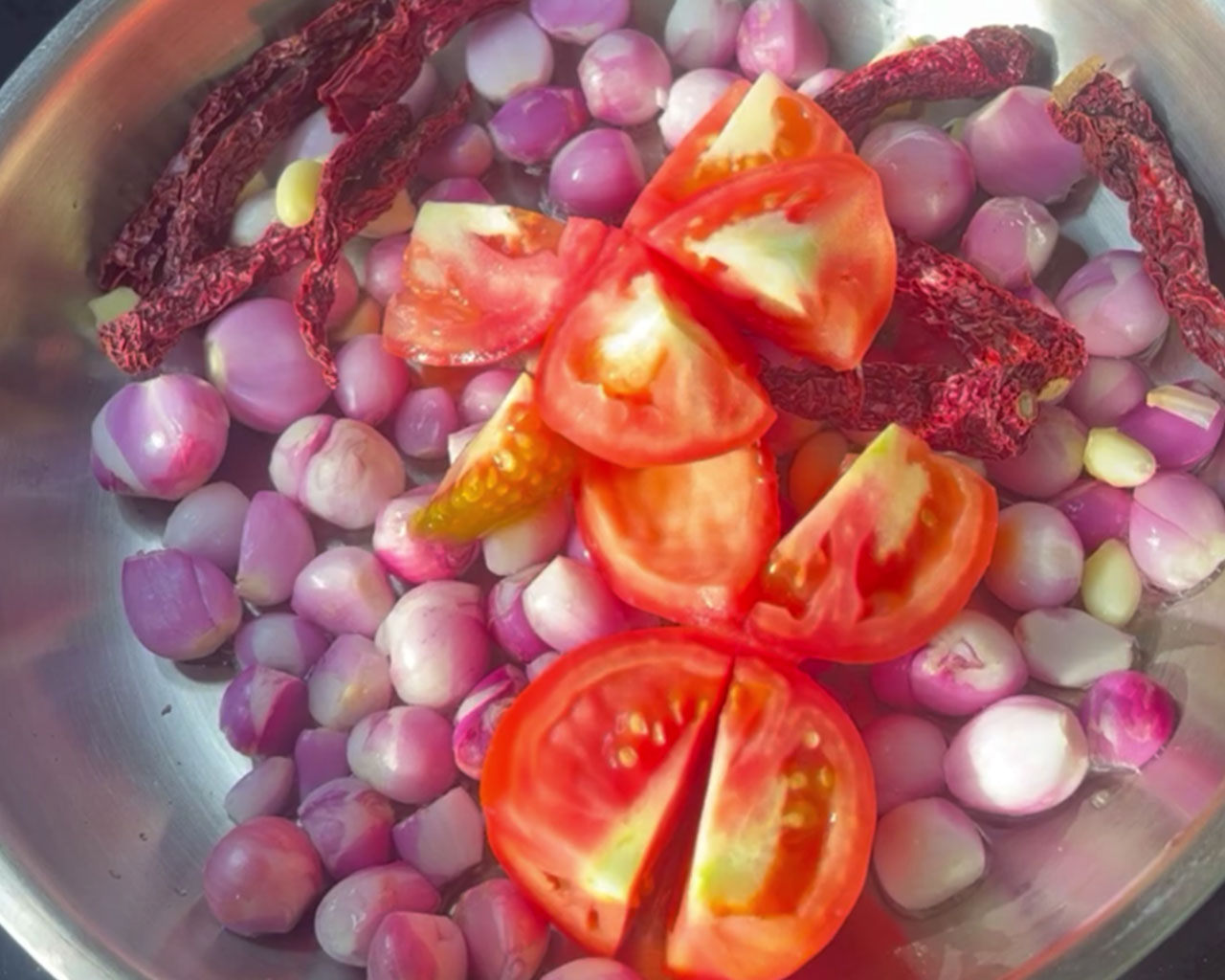 Chopped tomatoes added to the onion-garlic mix for chutney texture